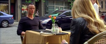 Movie still from “Don Jon” (2013), directed by Joseph Gordon-Levitt – A man sitting at a table in front of a woman; Medium shot, Over the shoulder angle
