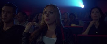Movie still from “Don Jon” (2013), directed by Joseph Gordon-Levitt – A woman is sitting in front of a group of people; Close Up shot, Low angle