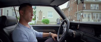 Movie still from “Don Jon” (2013), directed by Joseph Gordon-Levitt – A woman driving a car in a residential area; Medium shot, Low angle