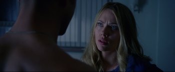 Movie still from “Don Jon” (2013), directed by Joseph Gordon-Levitt – A woman looking at a man in a dark room; Close Up shot, Over the shoulder angle