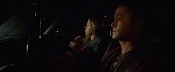Movie still from “Don Jon” (2013), directed by Joseph Gordon-Levitt – A man and a woman sitting in the drivers seat of a car at night; Medium shot, Over the shoulder angle
