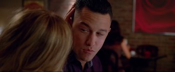 Movie still from “Don Jon” (2013), directed by Joseph Gordon-Levitt – A young man with his hand up to his ear; Close Up shot, Over the shoulder angle