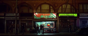 Movie still from “Don Jon” (2013), directed by Joseph Gordon-Levitt – A group of people standing in front of a pizza shop; Extreme Wide shot, High angle