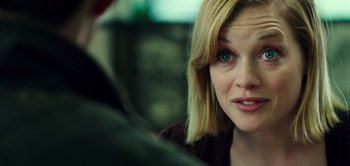 Movie still from “Don't Breathe” (2016), directed by Fede Alvarez – A person sitting down with her eyes wide open; Close Up shot, Over the shoulder angle