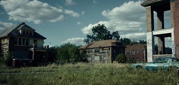Movie still from “Don't Breathe” (2016), directed by Fede Alvarez – An old house in the middle of a grassy field; Extreme Wide shot, Low angle