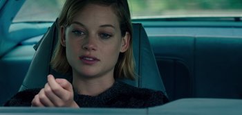 Movie still from “Don't Breathe” (2016), directed by Fede Alvarez – A woman sitting in the back seat of a car; Close Up shot, Over the shoulder angle