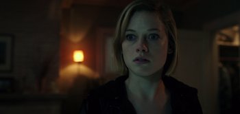 Movie still from “Don't Breathe” (2016), directed by Fede Alvarez – A woman with short blonde hair stares into the camera; Close Up shot, Over the shoulder angle