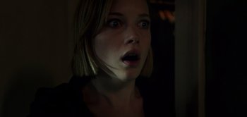Movie still from “Don't Breathe” (2016), directed by Fede Alvarez – A young woman with short blonde hair stares into the camera; Close Up shot, Low angle