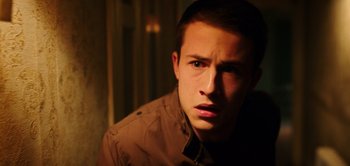 Movie still from “Don't Breathe” (2016), directed by Fede Alvarez – A young man in a brown jacket looking at the camera; Close Up shot, High angle