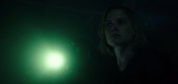 Movie still from “Don't Breathe” (2016), directed by Fede Alvarez – A woman standing in the dark with a green light in the background; Close Up shot, Low angle
