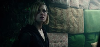 Movie still from “Don't Breathe” (2016), directed by Fede Alvarez – A woman standing in front of a pile of furniture; Medium shot, Low angle