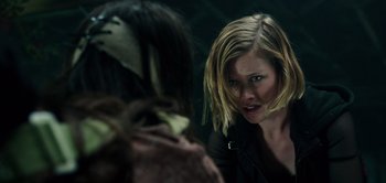 Movie still from “Don't Breathe” (2016), directed by Fede Alvarez – A woman is looking at another woman in a dark room; Close Up shot, Over the shoulder angle