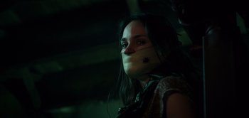 Movie still from “Don't Breathe” (2016), directed by Fede Alvarez – A woman with a bandage around her face; Close Up shot, Over the shoulder angle