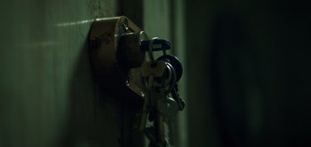 Movie still from “Don't Breathe” (2016), directed by Fede Alvarez – A bunch of keys hanging on the side of a wall; Extreme Close Up shot, High angle