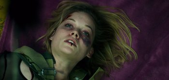 Movie still from “Don't Breathe” (2016), directed by Fede Alvarez – A woman with a black eye laying on the ground; Close Up shot, Overhead angle