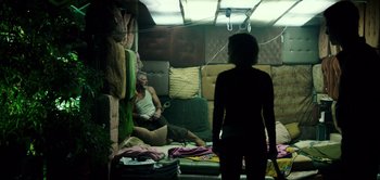 Movie still from “Don't Breathe” (2016), directed by Fede Alvarez – A man and a woman are sitting on a bed; Wide shot, Low angle