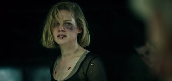 Movie still from “Don't Breathe” (2016), directed by Fede Alvarez – A young woman with a bruised face and a black shirt; Close Up shot, Over the shoulder angle