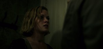 Movie still from “Don't Breathe” (2016), directed by Fede Alvarez – A woman looking at a man in a dark room; Close Up shot, Over the shoulder angle