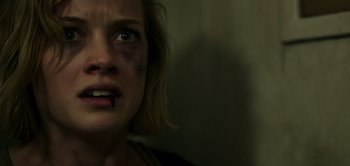 Movie still from “Don't Breathe” (2016), directed by Fede Alvarez – A person with a bruise on their face; Close Up shot, Over the shoulder angle