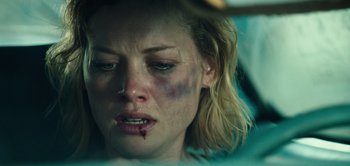 Movie still from “Don't Breathe” (2016), directed by Fede Alvarez – A person with bruises on her face; Close Up shot, Over the shoulder angle