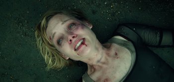 Movie still from “Don't Breathe” (2016), directed by Fede Alvarez – A woman with a bruised face laying on the ground; Close Up shot, Overhead angle