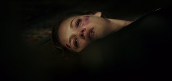 Movie still from “Don't Breathe” (2016), directed by Fede Alvarez – A woman's face in the dark; Close Up shot, Overhead angle
