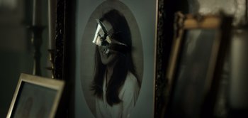 Movie still from “Don't Breathe” (2016), directed by Fede Alvarez – A picture of a woman's face with a broken mirror behind it; Extreme Close Up shot, Overhead angle