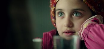 Movie still from “Don't Breathe” (2016), directed by Fede Alvarez – A young girl looking at the camera; Close Up shot, Over the shoulder angle