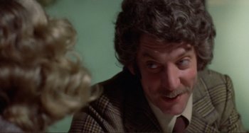 Movie still from “Don't Look Now” (1973), directed by Nicolas Roeg – A person wearing a suit and tie; Close Up shot, Over the shoulder angle