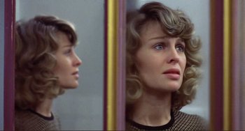 Movie still from “Don't Look Now” (1973), directed by Nicolas Roeg – A woman looking at her reflection in a mirror; Close Up shot, Over the shoulder angle