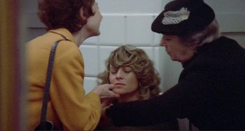 Movie still from “Don't Look Now” (1973), directed by Nicolas Roeg – A woman is getting her hair combed by two other women; Medium shot, High angle