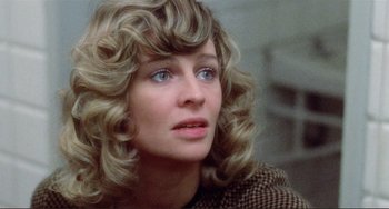 Movie still from “Don't Look Now” (1973), directed by Nicolas Roeg – A person with curly hair; Close Up shot, Over the shoulder angle