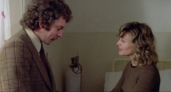 Movie still from “Don't Look Now” (1973), directed by Nicolas Roeg – A man and a woman standing next to each other in a room; Medium shot, Over the shoulder angle