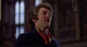 Movie still from “Don't Look Now” (1973), directed by Nicolas Roeg – A person with curly hair and a mustache; Close Up shot, Low angle