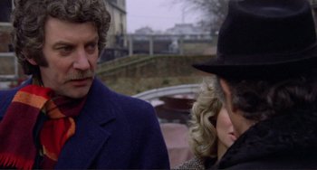 Movie still from “Don't Look Now” (1973), directed by Nicolas Roeg – A man and a woman wearing a hat and a suit; Close Up shot, Over the shoulder angle