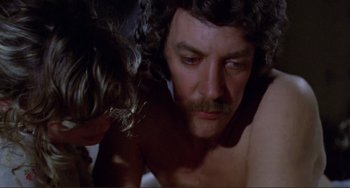 Movie still from “Don't Look Now” (1973), directed by Nicolas Roeg – A person laying on a bed near another person; Close Up shot, High angle