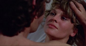 Movie still from “Don't Look Now” (1973), directed by Nicolas Roeg – A woman looking into a mirror while a man looks at her face; Close Up shot, Over the shoulder angle