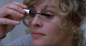 Movie still from “Don't Look Now” (1973), directed by Nicolas Roeg – A person putting a mascara brush on a woman's eye; Extreme Close Up shot, Over the shoulder angle