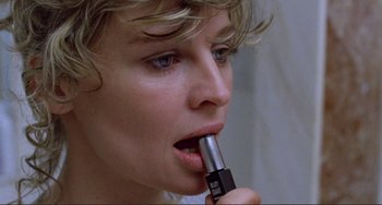 Movie still from “Don't Look Now” (1973), directed by Nicolas Roeg – A woman is holding a lipstick in her mouth; Extreme Close Up shot, High angle