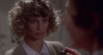 Movie still from “Don't Look Now” (1973), directed by Nicolas Roeg – A person in a mirror; Close Up shot, Over the shoulder angle