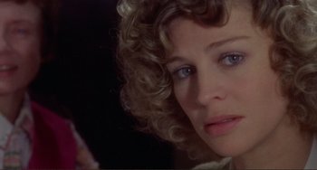 Movie still from “Don't Look Now” (1973), directed by Nicolas Roeg – A woman's face in a dark room; Close Up shot, Over the shoulder angle