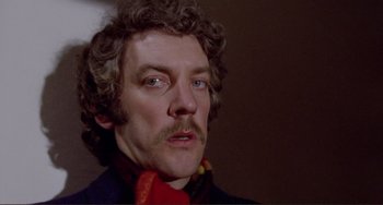 Movie still from “Don't Look Now” (1973), directed by Nicolas Roeg – A person with a mustache; Close Up shot, Low angle