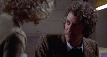 Movie still from “Don't Look Now” (1973), directed by Nicolas Roeg – A man in a suit and tie talking to another man in a suit and tie; Close Up shot, Over the shoulder angle