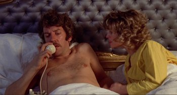 Movie still from “Don't Look Now” (1973), directed by Nicolas Roeg – A man laying in a bed with a woman; Medium shot, High angle