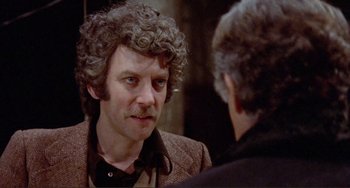 Movie still from “Don't Look Now” (1973), directed by Nicolas Roeg – A man with curly hair is looking at himself in the mirror; Close Up shot, Over the shoulder angle
