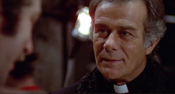 Movie still from “Don't Look Now” (1973), directed by Nicolas Roeg – A person wearing a priest's collar; Close Up shot, Low angle