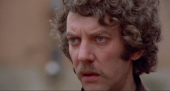 Movie still from “Don't Look Now” (1973), directed by Nicolas Roeg – A person with a beard and a mustache; Close Up shot, Low angle