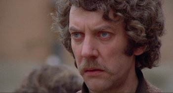 Movie still from “Don't Look Now” (1973), directed by Nicolas Roeg – A person with a beard and mustache; Close Up shot, Over the shoulder angle