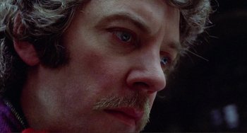 Movie still from “Don't Look Now” (1973), directed by Nicolas Roeg – A person's face with a beard; Close Up shot, Low angle