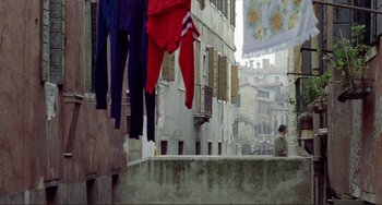 Movie still from “Don't Look Now” (1973), directed by Nicolas Roeg – Clothes hanging on a clothes line on a city street; Wide shot, Low angle